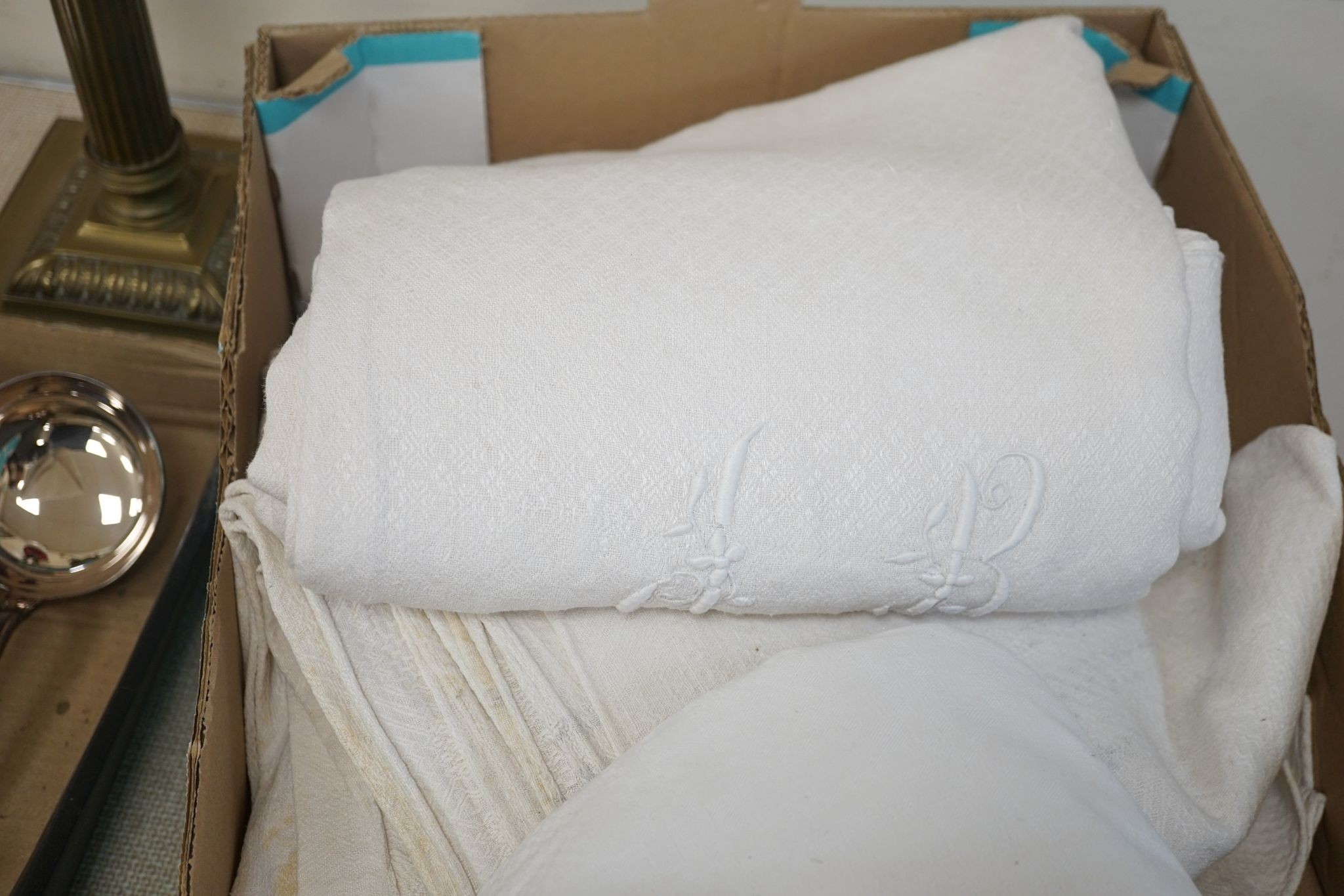 Two French provincial thick linen monogrammed tablecloths and three others.